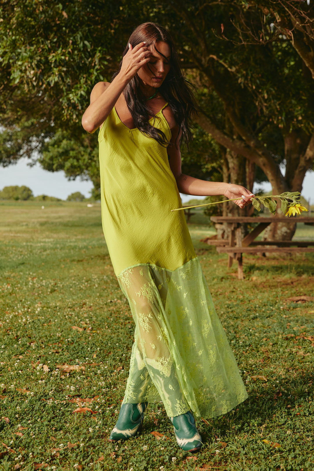 Person standing on grass wearing chartreuse Lace Maxi Dress.