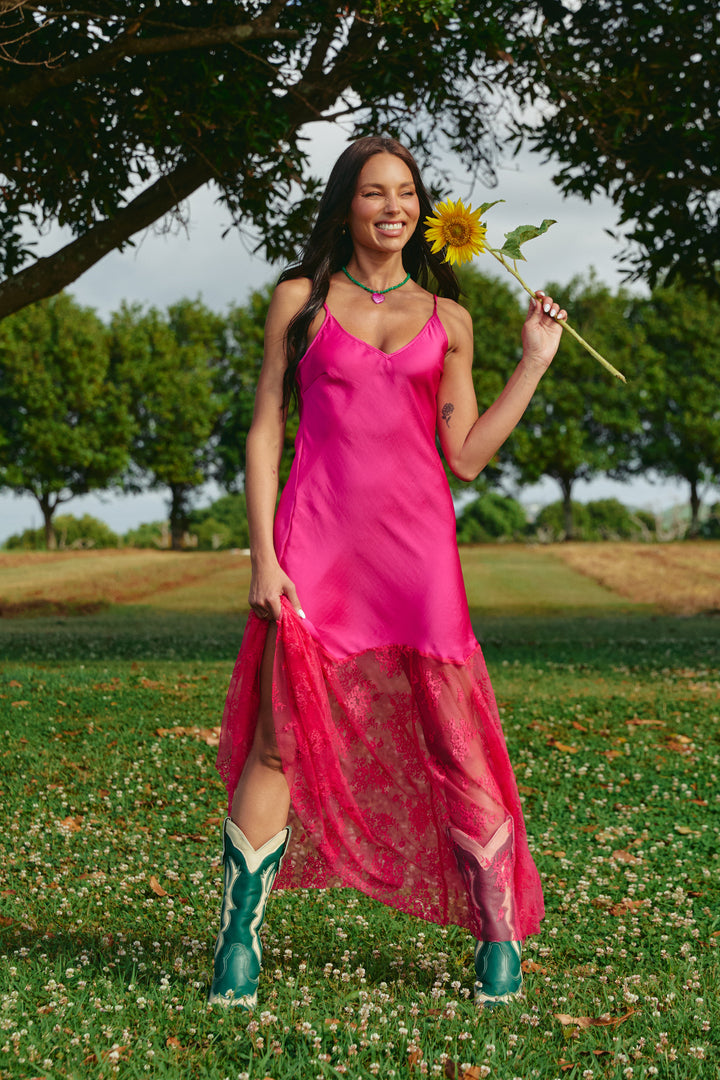Person standing on grass wearing pink Lace Maxi Dress.