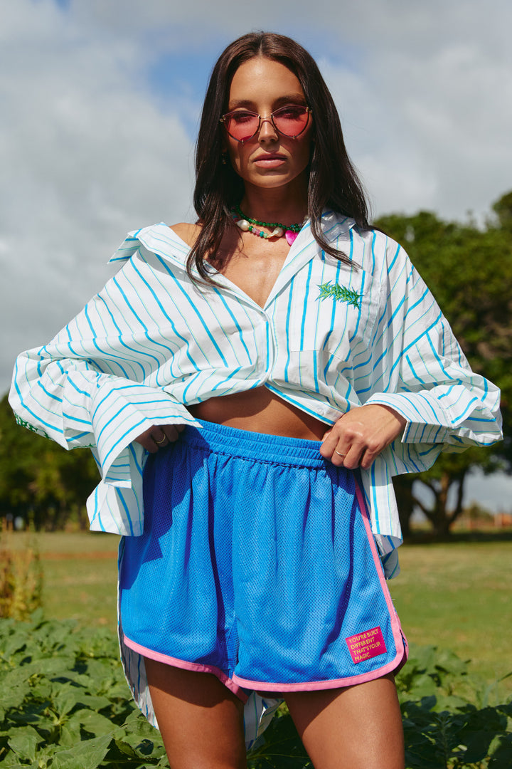 Person standing in sunflower field wearing blue Mesh Boxer Shorts.