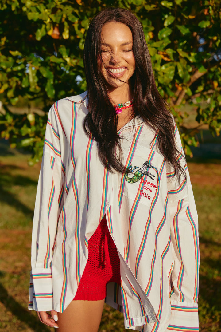 Person standing in front of a tree wearing Rainbow Dreams Don Julio Shirt