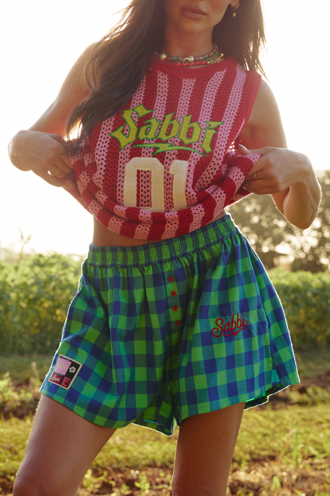 Person standing in sunflower field wearing  green check Be-youtiful Boxer Shorts.