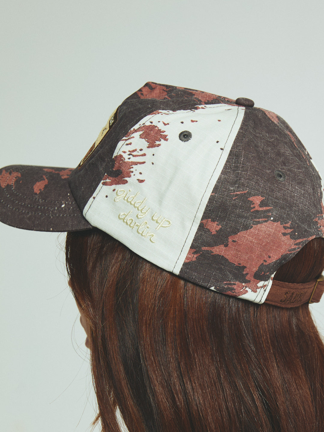 THE BUCK AROUND COW CAP