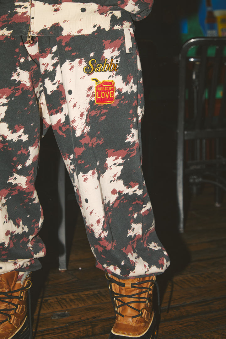 THE COW PRINT CUFFED SWEAT PANTS