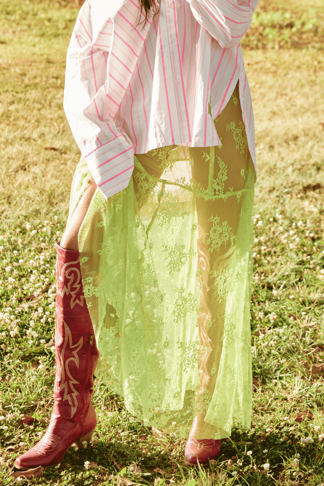 Person standing on grass wearing chartreuse Lace Maxi Skirt.