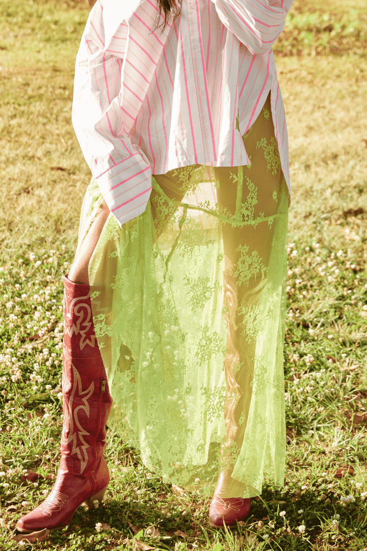 Person standing on grass wearing chartreuse Lace Maxi Skirt.