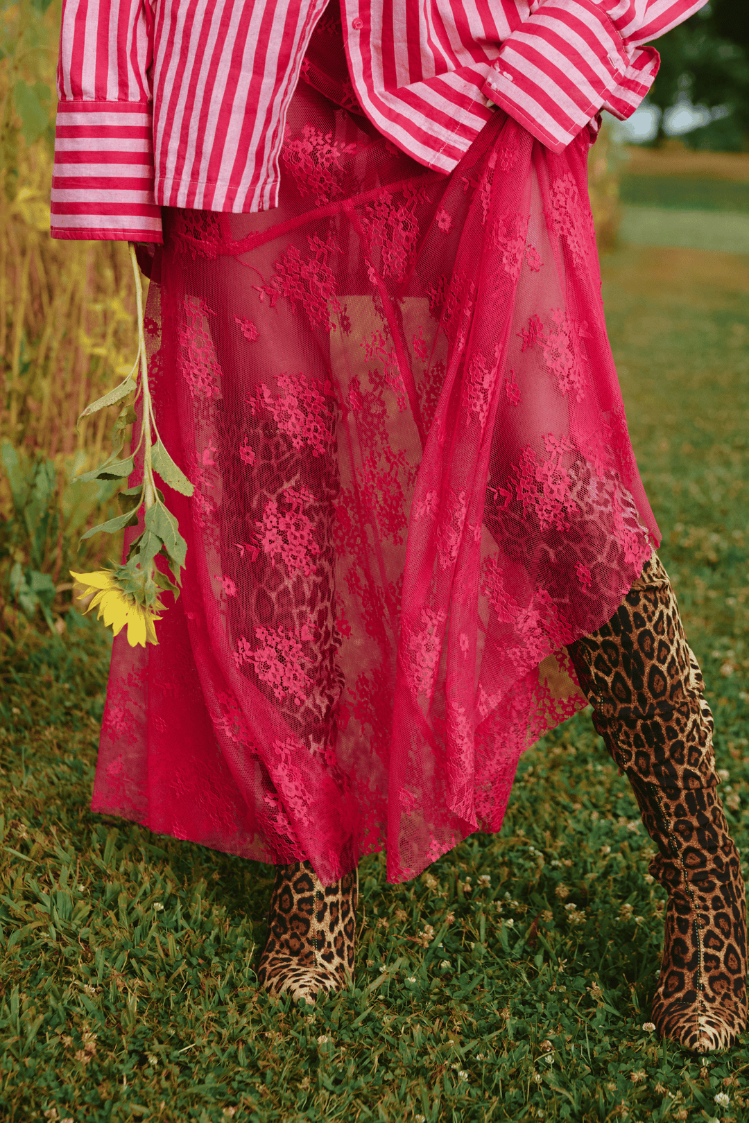 Person standing on grass wearing pink Lace Maxi Skirt.